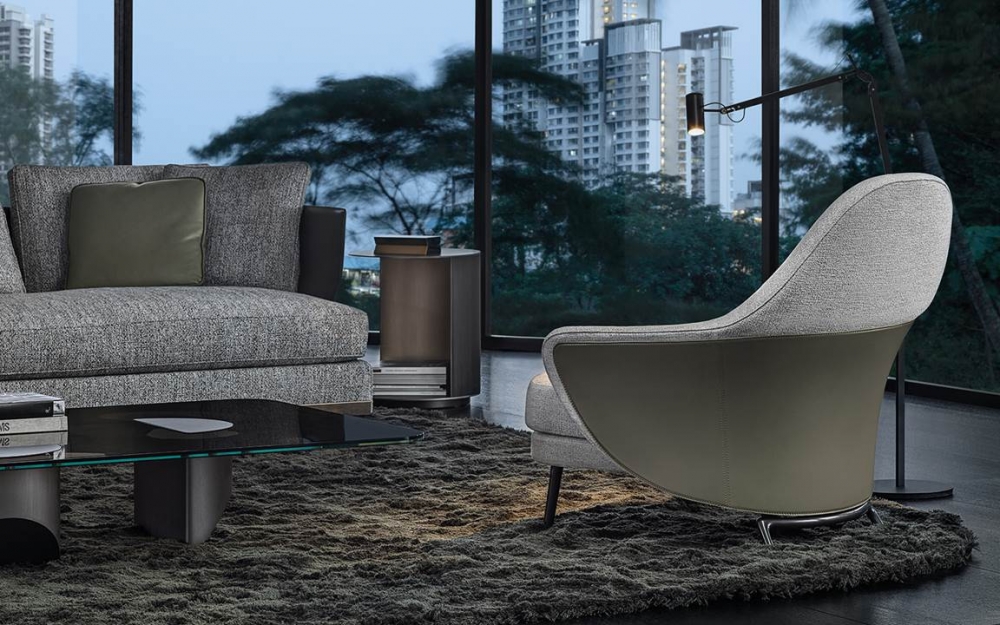 ANGIE armchair by GAMFRATESI STUDIO, designed in 2019. A saddle hide element designs a wing that embraces the armchair, sustaining the frame like a sculptural bustier characterized inside by the inviting softness. Behind the apparent simplicity of the design lies an advanced technological process used to make both the padding with different textures of foam and the saddle hide bustier, made using two different BAYDUR¬Æ moulds, which perfectly follows the curved line of the armchair and available in bordeaux, ash, dove grey, sage, mud, mocha and black colours.