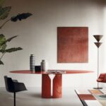 NVL TABLE by JEAN NOUVEL, designed in 2020. A mono-material table, with contemporary lines and characterized by a strong personality. It represents distinctive features of JEAN NOUVEL‚Äôs architecture ‚Äì pure geometric shapes, formal lightness, graphic lines, rigor.