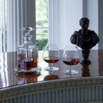 PERFECTION whiskey decanter. With the PERFECTION collection, the name says it all. As far back as Greek mythology, Pygmalion sought to sculpt to the perfect form of a woman; in the same storied fashion, the Perfection collection is expertly crafted by the modern Pygmalions, the most respected artisans of the m√©tier with supreme mastery of Baccarat‚Äôs flawless clear crystal. The stunning form is the perfect vessel in which to serve and enjoy a smooth drink. The diamond-cut beveled stopper crowns the decanter with geometric sophistication. The PERFECTION collection also includes champagne flutes, wine glasses, tumblers, and a pitcher.