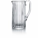 Baccarat HARMONIE pitche. Parallel vertical lines travel cleanly along the silhouette finely grazing the clear crystal form from the lip to the base. This linear emphasis evokes a thick clear crystal column.The stripes are subtly yet precisely etched into the clear crystal surface, showcasing the three-dimensionality of the pitcher and creating a visual depth to the liquid within. The vertical sweep of the striping is present throughout the HARMONIE collection, which includes highballs and tumblers and other pieces to complete a well-stocked bar. The HARMONIE pitcher is a stunning item that makes having a drink all the more enjoyable.