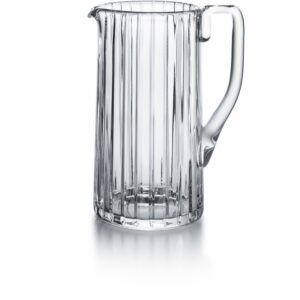 Baccarat HARMONIE pitche. Parallel vertical lines travel cleanly along the silhouette finely grazing the clear crystal form from the lip to the base. This linear emphasis evokes a thick clear crystal column.The stripes are subtly yet precisely etched into the clear crystal surface, showcasing the three-dimensionality of the pitcher and creating a visual depth to the liquid within. The vertical sweep of the striping is present throughout the HARMONIE collection, which includes highballs and tumblers and other pieces to complete a well-stocked bar. The HARMONIE pitcher is a stunning item that makes having a drink all the more enjoyable.