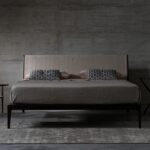 BRAD bed by STUDIO CC.A bed designed in 2010 by the internal CC STUDIO DESIGN GROUP. Materials, textures and different dimensions offer infinite customisation opportunities, from classic to more original looks. In fact, the geometric frame of the headboard is available with smooth or quilted padding. The cover, meanwhile, is available in fabric, leather or real leather. The frame of the BRAD bed is in solid American walnut with base in veneered plywood. Its simple elegance makes it perfect for relaxing in complete comfort.