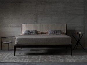 BRAD bed by STUDIO CC.A bed designed in 2010 by the internal CC STUDIO DESIGN GROUP. Materials, textures and different dimensions offer infinite customisation opportunities, from classic to more original looks. In fact, the geometric frame of the headboard is available with smooth or quilted padding. The cover, meanwhile, is available in fabric, leather or real leather. The frame of the BRAD bed is in solid American walnut with base in veneered plywood. Its simple elegance makes it perfect for relaxing in complete comfort.