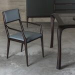 ALA chair with armrest designed by GIUSEPPE CASAROSA. Chair made in solid American walnut or ash. Seat and back-rest in upholstered poplar plywood.