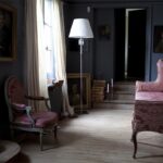 TORCH SMALL floor lamp designed by ARIK LEVY. The TORCH range draws inspiration from the exquisite Z√©nith chandelier reinventing its illustrious elements. Pairing clear crystal with shiny metal gives the product a modern feel: the long and slender polished stainless steel base is juxtaposed with dangling crystal pendants and Baccarat‚Äôs special red octagonal crystal. The lamp balances sophisticated technology with poetic whimsy and a purity, via the white shade. Its height makes it a suitable reading lamp or a standalone piece. The lamp is also available with an inverted black lampshade (placed upside down for a dash of humor), and in various other models, namely a wall sconce, and pendant light.