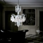 Crystal chandelier 18 lights SOLSTICE. The bellcaps at the ends of the branches imbue a graceful weightlessness. Available in 2 sizes. The number of lights ranges widely, from 6 to 48. Regardless of density, each chandelier is composed of hollow branches crafted from blown cabled crystal, resplendently showcasing Baccarat‚Äôs masterful craftsmanship. The wealth of decoration is all cut in a diamond-point design. Amongst the spiked prisms, Baccarat signature‚Äôs red octagonal crystal hangs discreetly.