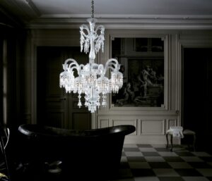 Crystal chandelier 18 lights SOLSTICE. The bellcaps at the ends of the branches imbue a graceful weightlessness. Available in 2 sizes. The number of lights ranges widely, from 6 to 48. Regardless of density, each chandelier is composed of hollow branches crafted from blown cabled crystal, resplendently showcasing Baccarat‚Äôs masterful craftsmanship. The wealth of decoration is all cut in a diamond-point design. Amongst the spiked prisms, Baccarat signature‚Äôs red octagonal crystal hangs discreetly.