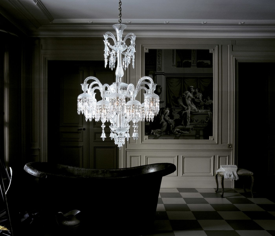 Crystal chandelier 18 lights SOLSTICE. The bellcaps at the ends of the branches imbue a graceful weightlessness. Available in 2 sizes. The number of lights ranges widely, from 6 to 48. Regardless of density, each chandelier is composed of hollow branches crafted from blown cabled crystal, resplendently showcasing Baccarat‚Äôs masterful craftsmanship. The wealth of decoration is all cut in a diamond-point design. Amongst the spiked prisms, Baccarat signature‚Äôs red octagonal crystal hangs discreetly.