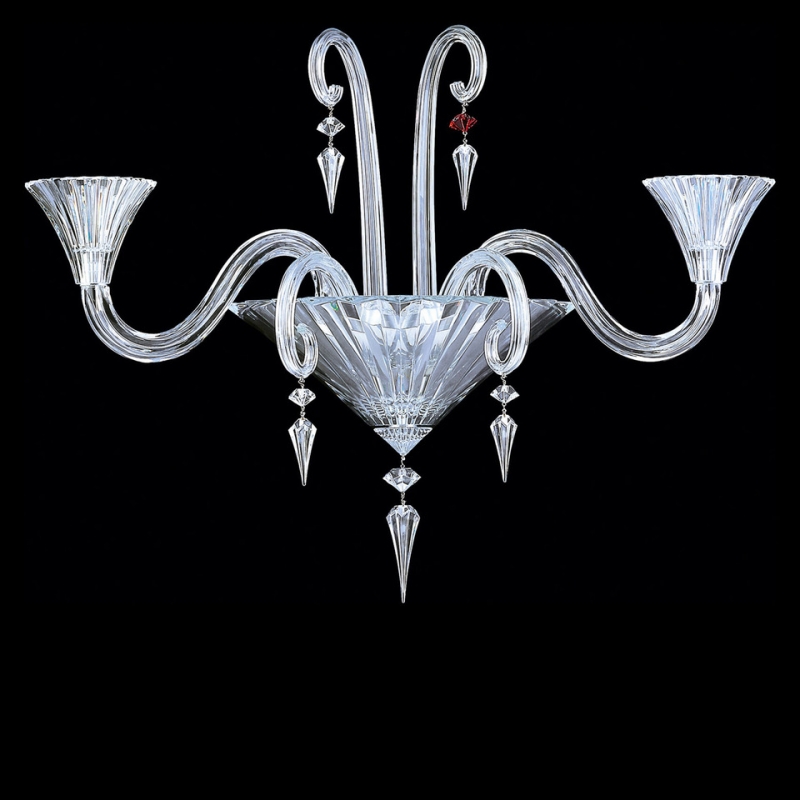 MILLE NUITS wall sconce. Ornamental beads in prismatic hexagonal shapes, amongst them Baccarat signature‚Äôs single red crystal, hang resplendently and richly refract the light. The shape MILLE NUITS unit further highlights the crystal‚Äôs exceptional light-scattering properties. Mille Nuits is a reference to the 1001 Tales of The Arabian Nights. Designed by MATHIAS for Baccarat, the collection also extends to stemware and home d√©cor.