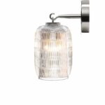 C√âLESTE wall lamp designed by PHILIPPE NIGRO. Inspired by the outline of some types of Japanese lantern, the C√âLESTE collection takes a new look at the rice grain elongated bevel cut. As a suspension or a wall light, placed on the ground or on its stand, these items provide a golden halo of light.