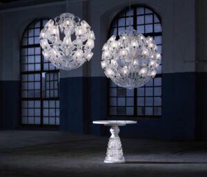LE ROI SOLEIL chandelier by MARCEL WANDERS Studio. This majestic chandelier, a contemporary twist of the iconic Z√©nith chandelier, is revealed under a new light thanks to its current and timeless spherical figure. Cabled arms in the grand tradition of glassmaking and its round shape-cut curved crystal lampshades have been specifically conceived to draw a perfect spherical shape. Spiked prisms, festoons of octagons and scrolls come adorning this 40L chandelier. A red crystal octagon represents the Baccarat signature and is linked to a spiked prism signed by MARCEL WANDERS Studio. Chandelier ompatible with chains and canopies for 36-48L chandeliers.