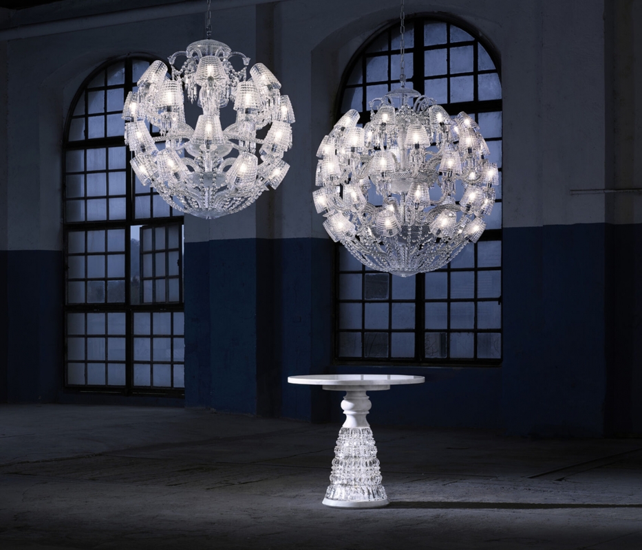 LE ROI SOLEIL chandelier by MARCEL WANDERS Studio. This majestic chandelier, a contemporary twist of the iconic Z√©nith chandelier, is revealed under a new light thanks to its current and timeless spherical figure. Cabled arms in the grand tradition of glassmaking and its round shape-cut curved crystal lampshades have been specifically conceived to draw a perfect spherical shape. Spiked prisms, festoons of octagons and scrolls come adorning this 40L chandelier. A red crystal octagon represents the Baccarat signature and is linked to a spiked prism signed by MARCEL WANDERS Studio. Chandelier ompatible with chains and canopies for 36-48L chandeliers.