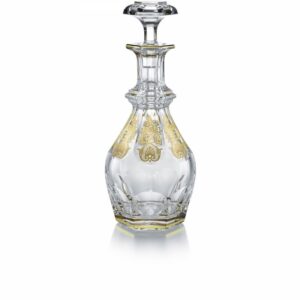 The HARCOURT EMPIRE decanter revisits the HARCOURT‚Äôs regal architectural form. The HARCOURT collection, created in 1841, is the oldest in the Baccarat archive and reputed for its iconic design. The HARCOURT EMPIRE decanter shares the same structure as the HARCOURT 1841 square whiskey decanter, but adorned with exquisite golden embellishment. Each flat cut side has gilded decorative shapes applied with a light hand, and a gold trim around the perimeter of both the decnater‚Äôs neck and base. The diamond-cut beveled stopper crowns the classical shape with geometric sophistication. The HARCOURT EMPIRE collection, a showcase of sparkling lucid crystal complemented by graceful gold, also includes a wine glass, highball glass, and champagne flute. Baccarat‚Äôs Rivoli stemware collection has gilded features as well.