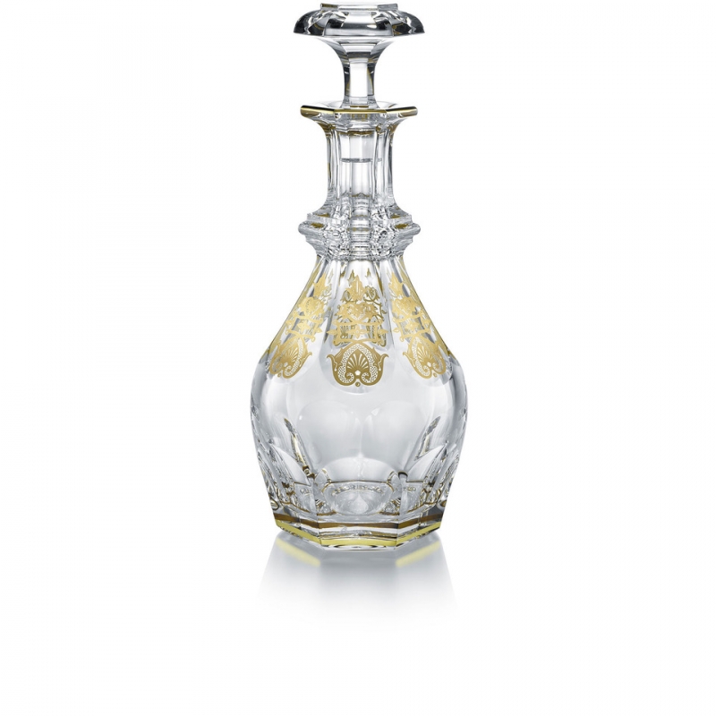 The HARCOURT EMPIRE decanter revisits the HARCOURT‚Äôs regal architectural form. The HARCOURT collection, created in 1841, is the oldest in the Baccarat archive and reputed for its iconic design. The HARCOURT EMPIRE decanter shares the same structure as the HARCOURT 1841 square whiskey decanter, but adorned with exquisite golden embellishment. Each flat cut side has gilded decorative shapes applied with a light hand, and a gold trim around the perimeter of both the decnater‚Äôs neck and base. The diamond-cut beveled stopper crowns the classical shape with geometric sophistication. The HARCOURT EMPIRE collection, a showcase of sparkling lucid crystal complemented by graceful gold, also includes a wine glass, highball glass, and champagne flute. Baccarat‚Äôs Rivoli stemware collection has gilded features as well.