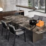 LINHA DINING TABLE by MARCIO KOGAN (STUDIO MK27), designed in 2020. Expression of the minimalism that pervades the Brazilian architect‚Äôs designs, the LINHA DINING TABLE is a manifesto of his constant pursuit of elegance in the proportions of his creations, and of his almost obsessive attention to detail. LINHA, or line in Portuguese, is his response to the challenge of designing a dining table with a large span, a frame only 16 mm thick and a top that can reach up to 4 metres in length. Visually, it appears extremely lightweight and aerial, despite the strong impact of the materials used, in which marble boldly takes center stage.