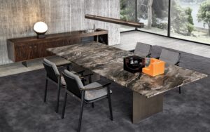 LINHA DINING TABLE by MARCIO KOGAN (STUDIO MK27), designed in 2020. Expression of the minimalism that pervades the Brazilian architect‚Äôs designs, the LINHA DINING TABLE is a manifesto of his constant pursuit of elegance in the proportions of his creations, and of his almost obsessive attention to detail. LINHA, or line in Portuguese, is his response to the challenge of designing a dining table with a large span, a frame only 16 mm thick and a top that can reach up to 4 metres in length. Visually, it appears extremely lightweight and aerial, despite the strong impact of the materials used, in which marble boldly takes center stage.