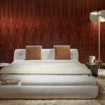 SUPERMOON bed by GIAMPIERO TAGLIAFERRI, designed in 2024.The mattress is accommodated inside the upholstered shell-shaped base, which rests on large stainless steel discs.  The super-comfy, enveloping design of the headboard echoes that of the seating system‚Äôs backrests and armrests, poetically reminiscent of a lunar phase, becoming the stylistic hallmark of this furnishing piece as well. The sommier and its multiple pocket springs guarantee a high quality of rest.  As an evolution of the modular system, SUPERMOON bed is designed specifically for the bedroom and expresses an ideal of timeless beauty, capable of creating a unique, cosy atmosphere all around.