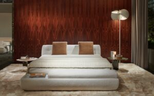 SUPERMOON bed by GIAMPIERO TAGLIAFERRI, designed in 2024.The mattress is accommodated inside the upholstered shell-shaped base, which rests on large stainless steel discs.  The super-comfy, enveloping design of the headboard echoes that of the seating system‚Äôs backrests and armrests, poetically reminiscent of a lunar phase, becoming the stylistic hallmark of this furnishing piece as well. The sommier and its multiple pocket springs guarantee a high quality of rest.  As an evolution of the modular system, SUPERMOON bed is designed specifically for the bedroom and expresses an ideal of timeless beauty, capable of creating a unique, cosy atmosphere all around.