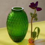 PLUMES vase -In the Amazon forest, quietly lurking in the flamboyant green foliage, lives this parrot with its characteristic plumage Its camouflage makes it barely visible Like the light coming through the tropical canopy, the purity of the reflects and the radiance of the crystal are fascinating The softness of the pattern comforts and invites to touch, to caress.