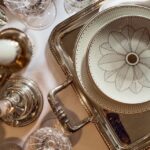 Porcelain tableware MALMAISON IMP√âRIALE. Christofle takes the emblematic codes of the MALMAISON model and interprets them in a modern and feminine version with MALMAISON IMP√âRIALE. You will find the flower of the handle hoods of MALMAISON  pieces. Each piece has its own decoration and thus allows you to vary your table according to the moments of tasting.