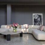 GOGAN SOFA BY PATRICIA URQUIOLA.THE DESIGN IS INSPIRED BY PEBBLES ON RIVERBANKS, WORN SMOOTH BY THE FLOW OF WATER AND OFTEN FEATURED IN JAPANESE ORNAMENTAL GARDENS. THE ORGANIC NATURE OF THE DESIGN IS EMPHASISED BY THE IRREGULAR SHAPE OF THE SEAT AND BACK, EXTRA SMOOTH EDGES AND CONCEALED SEAMS. THE BUTTRESS-LIKE FRAME, VISIBLE AT THE BACK OF THE SOFA, CREATES A SENSE OF LIGHTNESS BY LIFTING THE SEAT OFF THE FLOOR AND CREATING A GAP BETWEEN THE SEAT AND THE BACKREST. THE RESULT IS A BEAUTIFULLY SCULPTURAL SOFA WHICH FEELS MONUMENTAL AND LIGHT AT THE SAME TIME, PERFECT FOR USE IN BOTH RESIDENTIAL AND PUBLIC AREAS.