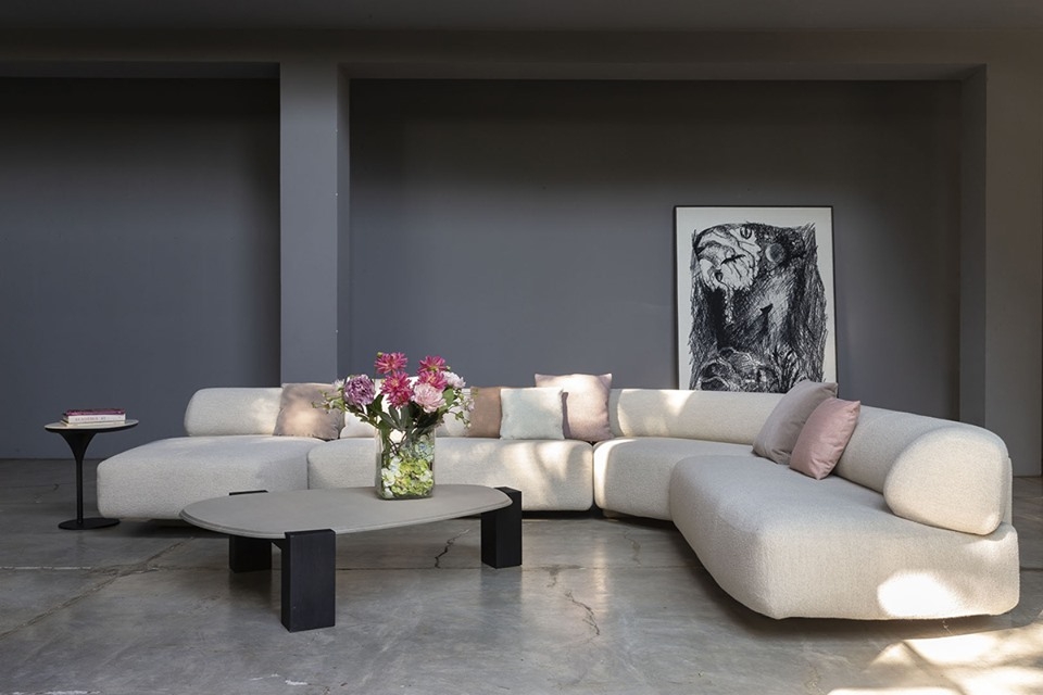 GOGAN SOFA BY PATRICIA URQUIOLA.THE DESIGN IS INSPIRED BY PEBBLES ON RIVERBANKS, WORN SMOOTH BY THE FLOW OF WATER AND OFTEN FEATURED IN JAPANESE ORNAMENTAL GARDENS. THE ORGANIC NATURE OF THE DESIGN IS EMPHASISED BY THE IRREGULAR SHAPE OF THE SEAT AND BACK, EXTRA SMOOTH EDGES AND CONCEALED SEAMS. THE BUTTRESS-LIKE FRAME, VISIBLE AT THE BACK OF THE SOFA, CREATES A SENSE OF LIGHTNESS BY LIFTING THE SEAT OFF THE FLOOR AND CREATING A GAP BETWEEN THE SEAT AND THE BACKREST. THE RESULT IS A BEAUTIFULLY SCULPTURAL SOFA WHICH FEELS MONUMENTAL AND LIGHT AT THE SAME TIME, PERFECT FOR USE IN BOTH RESIDENTIAL AND PUBLIC AREAS.