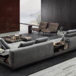 CONNERY seating system by RODOLFO DORDONI, designed in 2020. The leather bands of the structural base, sewn together with straps and marked out by stitching that add rhythm to the design, are made with the same technique used in fine leather luggage-making. The same concept of high-end leather goods also inspires the freely adjustable headrests