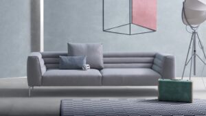 MONOBLOC SOFA BOTERO BY DAMIAN WILLAMSON 2016.POLISHED OR BLACK PAINTED ALUMINUM ALLOY FEET. STEEL FRAME. ELASTIC STRIPS SUSPENSION. BACKREST AND SEAT UPHOLSTERED IN GRADUATED POLYURETHANE/HEAT-BOUND POLYESTER FIBRE. REMOVABLE COVER IN FABRIC OR LEATHER. THE SOFA CAN BE EQUIPPED WITH CUSHIONS  UPHOLSTERED IN POLYURETHANE/DACRON DU PONT OR IN GOOSE DOWN ‚Äì 100% PURE MATERIAL. UPON REQUEST THE SEWING EDGE OF THE ARMREST, BACKREST AND CUSHIONS IS AVAILABLE IN DARK GREY GROSGRAIN.