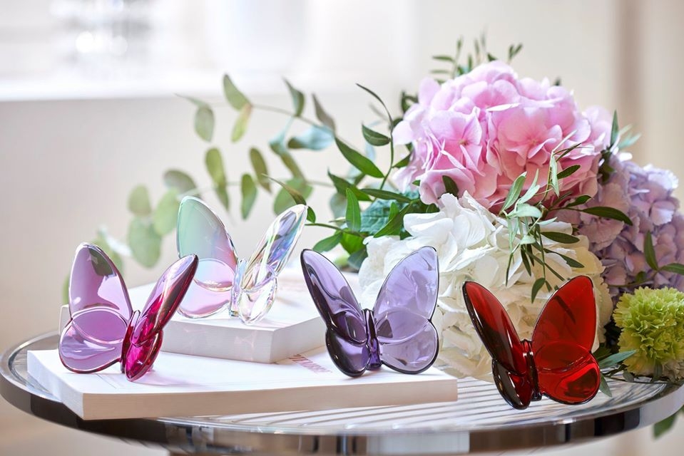 PAPILLON LUCKY BUTTERFLY. The poetic contours highlight Baccarat‚Äôs signature craftsmanship. Placed anywhere in the home, the Baccarat LUCKY BUTTERFLY elicits a sense of momentum and graceful √©lan. Designed for Baccarat by EVELYNE JULIENNE, this fascinating creature comes in a wide variety of available colors including: blue, peony, ruby red, amber, turquoise blue crystal, black, gold, blue scarabee and clear iridescent crystal (with tinges of green, yellow and blue).