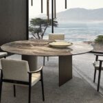 LINHA DINING TABLE by MARCIO KOGAN (STUDIO MK27), designed in 2020. In the round top version, the cross-section of the blade-like legs is not rectangular, but slightly curved on the inside.