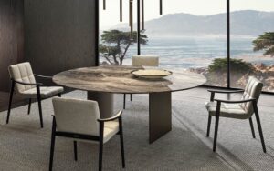 LINHA DINING TABLE by MARCIO KOGAN (STUDIO MK27), designed in 2020. In the round top version, the cross-section of the blade-like legs is not rectangular, but slightly curved on the inside.