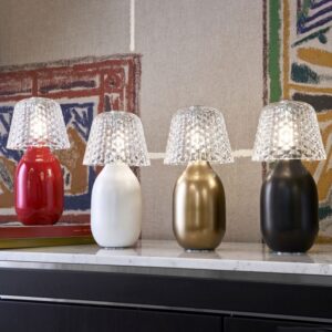 BABY CANDY LIGHT nomadic lamp. BABY CANDY LIGHT becomes now nomadic in 4 iconic colors: glossy Baccarat red, matte bronze, matte white and matte black. Wireless, this nomadic lamp is an elegant and playful solution to light up and decorate indoor tables as well as terrace tables. Rechargeable, its ceramic body is topped with a crystal shade inspired by the Juvisy-cut motif. A button on the top of the lampshade enables to dim the light by a gentle and continuous touch.