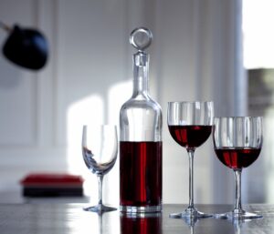 DYONISOS decanter designed by VAN DAY TRUEX. Decanting a young wine allows its undertones to flourish, and decanting may also be a fitting option for an older wine that has yet to attain complete maturity. The DIONYSUS decanter is not only a vehicle that helps the wine reach its full integrity; it is also a stunningly crafted piece. The minimalist silhouette resembles a clear crystal Bordeaux wine bottle. The poise of the slender neck morphs gracefully into the base, and the stopper caps off the sleek form with a perfectly rounded globe of Baccarat clear crystal. Designed by VAN DAY TRUEX, the understated shape matches seamlessly with any Baccarat bar and stemware set.