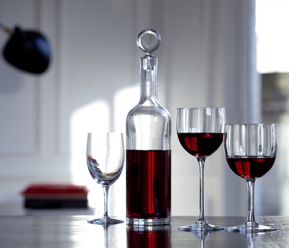 DYONISOS decanter designed by VAN DAY TRUEX. Decanting a young wine allows its undertones to flourish, and decanting may also be a fitting option for an older wine that has yet to attain complete maturity. The DIONYSUS decanter is not only a vehicle that helps the wine reach its full integrity; it is also a stunningly crafted piece. The minimalist silhouette resembles a clear crystal Bordeaux wine bottle. The poise of the slender neck morphs gracefully into the base, and the stopper caps off the sleek form with a perfectly rounded globe of Baccarat clear crystal. Designed by VAN DAY TRUEX, the understated shape matches seamlessly with any Baccarat bar and stemware set.