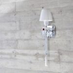 ORCH wall scone. Designed by ARIK LEVY, the TORCH wall lamp topped by a lampshade with pleated taffetas was inspired by the emblematic Z√©nith chandelier, which it partly reinvents.