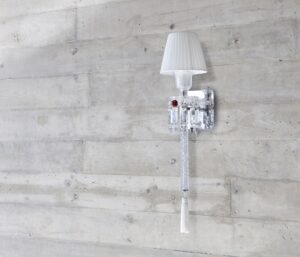 ORCH wall scone. Designed by ARIK LEVY, the TORCH wall lamp topped by a lampshade with pleated taffetas was inspired by the emblematic Z√©nith chandelier, which it partly reinvents.