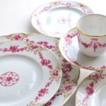 FINE GOLD BAND AND GARLAND OF ROSES IN A UNIQUE COLOR KNOWN AS ‚ÄúCAMEOED CARMINE‚Äù AND PUNCTUATED BY GILDED, LOUIS XV-STYLE SCROLLS FOR THIS EXCEPTIONAL SERVICE BY THE ANCIENNE MANUFACTURE ROYALE