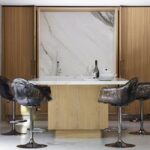 ELLA BAR CHAIR BY JACOPO FOGGINI.CHAIR WITH ARMRESTS, ENTIRELY HANDMADE IN POLYCARBONATE. IT IS SUPPORTED BY A PEDESTAL THAT ALLOWS ROTATION WHICH STEM IS BLACK AND THE PETALS OF TRANSPARENT AND SOFT HUES MIX GREEN AND BLUE OR GOLD OR ANTHRACITE, RECALLS THE SHAPE OF A FLOWER. THE ELEGANT, COMFORTABLE SEAT PERFECTLY FITS IN WITH ANY SETTING. EACH PIECE IS UNIQUE, AS IT IS SHAPED BY HAND.