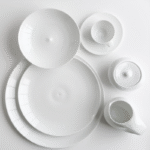 Porcelain tableware BULLE. The shape of Bulle expands the range of choices for the White Table. The motif recalls ripples on the surface of water and the collection offers several new pieces whose use is dictated by the elegance of fine dining.