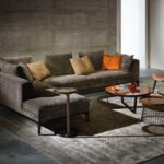 Don Giovanni Sofa by Giuseppe Casarosa. Create a classic and contemporary look by choosing refined materials and well-balanced volumes. The vast range of terminal and angular units, chaise longue and poufs, along with two different depths for some elements, allows various solutions. Internal structure made in plywood, base in solid American walnut, upholstered seat and back-rest covered in fabric, leather or natural leather, leg tips in brass. To complete the collection a console in two dimensions and a side table. Accessories necessary to optimize and personalize the space.