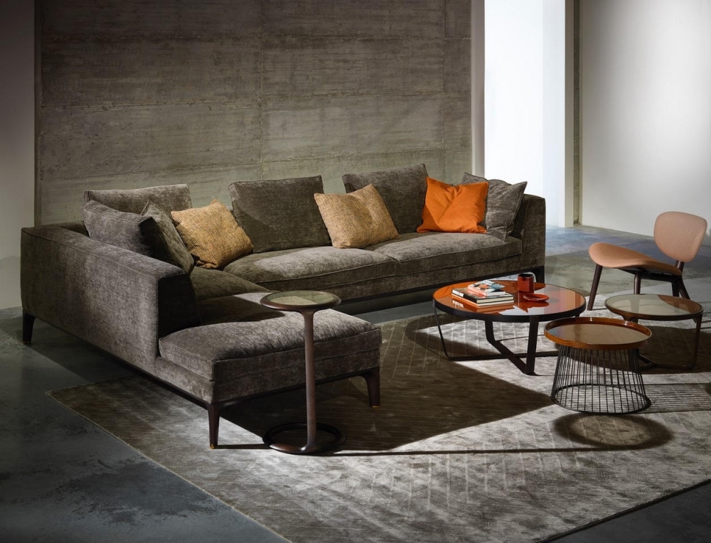 Don Giovanni Sofa by Giuseppe Casarosa. Create a classic and contemporary look by choosing refined materials and well-balanced volumes. The vast range of terminal and angular units, chaise longue and poufs, along with two different depths for some elements, allows various solutions. Internal structure made in plywood, base in solid American walnut, upholstered seat and back-rest covered in fabric, leather or natural leather, leg tips in brass. To complete the collection a console in two dimensions and a side table. Accessories necessary to optimize and personalize the space.