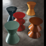 CESAR ACCENT TABLE by RODOLFO DORDONI, designed in 2004. Whether it presents itself as a side table, pouf or decor element, CESAR, with its eclectic personality and strong formal presence, has definitely joined the icons of MINOTTI, becoming an undisputed global best-seller. Designed by RODOLFO DORDONI in 2004, this year, the famous sculpture-object is turning this year 15 years old. For use in a group composition, or on its own, it comes in two different forms moulded in structural polyurethane, a material that cannot be deformed or altered. With a versatile range of uses, it is a true all-purpose piece of furniture, capable of migrating from the living area to the bedroom, from residential environments to those of the hospitality industry and even to workplaces. The story of CESAR has been told over the years through a vibrant palette of no less than 17 glossy lacquered finishes. In 2019, an important intervention on the colour scheme has entailed the addition of the powder pink colour to the current range of glossy colour variants and the introduction of three new shades - sage, bordeaux and mocha - in a brand new matt finish.