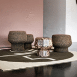 CORKER designed by HERZOG & DE MEURON. Warm, grounding, stable and flexible in the ways it can be used: CORKER is one of those universal talents that simply look good in any environment as an extra seat or side table. CORKER is available in three sizes and plays with its nature not only in its name but also in its design: The silhouette of a wine bottle cork served as inspiration. The piece of furniture can almost be viewed as a pop art object due to its direct, simply enlarged reference to an object taken from everyday culture.  CORKER originated at the London Serpentine Gallery Pavilion 2012. The design of the temporary summer pavilion was a joint project by the architectural office HERZOG & DE MEURON and Chinese artist, designer and architect AI WEIWEI. THE cork design object was part of the overall concept.