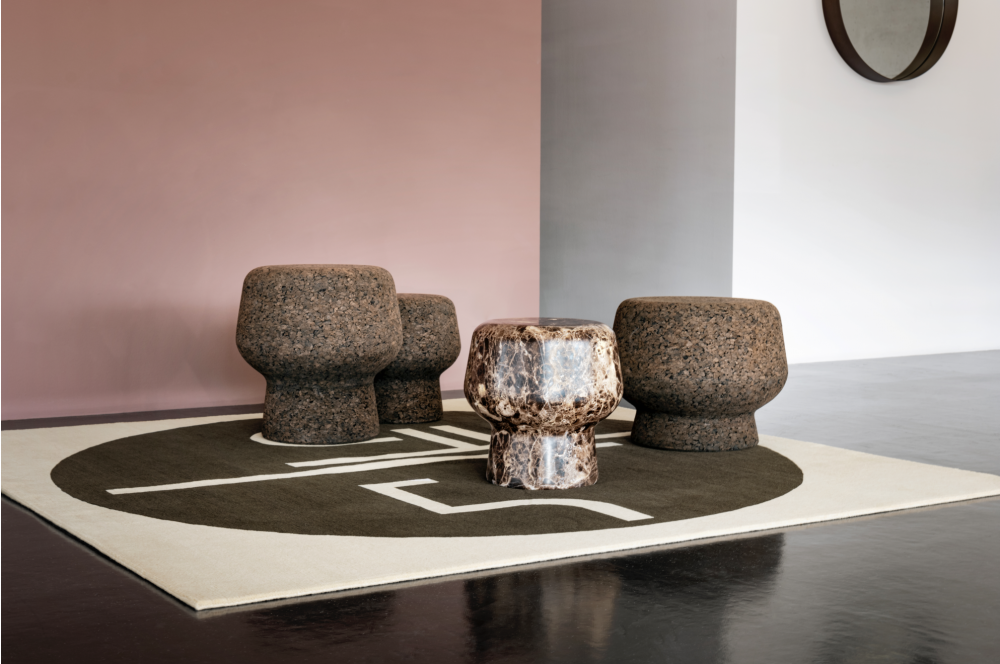 CORKER designed by HERZOG & DE MEURON. Warm, grounding, stable and flexible in the ways it can be used: CORKER is one of those universal talents that simply look good in any environment as an extra seat or side table. CORKER is available in three sizes and plays with its nature not only in its name but also in its design: The silhouette of a wine bottle cork served as inspiration. The piece of furniture can almost be viewed as a pop art object due to its direct, simply enlarged reference to an object taken from everyday culture.  CORKER originated at the London Serpentine Gallery Pavilion 2012. The design of the temporary summer pavilion was a joint project by the architectural office HERZOG & DE MEURON and Chinese artist, designer and architect AI WEIWEI. THE cork design object was part of the overall concept.