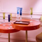 MILLE NUITS flutissimo set designed by MATHIAS. A set of 4 Flutissimo champagne flutes: blue, moss, red and amber. Slightly curved lines & flared optic glass enhance the reflection of light and give the flutes a charming style.  A powerful crystal expression thanks to its narrow cut bevels. The baroque spirit of the MILLE NUITS collection refers to the world of tales from the Thousand & One Nights. This collection expresses all the charm of the mythical Orient: THE VENETIAN STYLE evokes the richness of magnificent fabrics found in palaces, and the narrow cut brings to mind the delicate glittering of light.