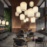 PLISS√âE pendant lamp by SEBASTIAN HERKNER ‚Äì 2023. Made of mouth-blown opal glass, the PLISS√âE lampshade balances in the air like a delicate balloon of light. The elaborately pleated structure is handcrafted in a traditional Italian manufactory, lending the luminaire its soft, almost textile look. To a certain extent, SEBASTIAN HERKNER‚Äôs design references the famous paper lanterns from Japan and the lighting design by ISAMU NOGUCHI. The glass shade of PLISS√âE is frosted white on both the interior and exterior surface, creating a pleasant ambient light and also a light cone directed downwards. Two metal rings made of lacquered aluminium ‚Äì optionally in black, bronze or brass ‚Äì are attached to the upper bracket and to the lower opening.