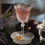 DIAMANT glass. THOMAS BASTIDE'S stylish clear crystal DIAMANT collection draws inspiration from Baccarat heritage in reviving the charm of the pointed diamond cut to complement the slender, graceful forms of this glass. The glass is shaped in a glittering display of baccarat craftsmanship. The striking design stands out as a timeless baccarat classic. The collection comprises glasses in four sizes and a champagne flute as well as a set of three matching tumblers.