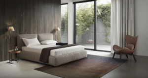 MAGENTA bed designed by DANIELE  LO SCALZO MOSCHERI. MAGENTA is an unfussy linear bed with a pristine well-proportioned design which makes it easy to fit into any setting. Its unassuming beauty turns the bed into a hospitable haven and gives the bedroom area an elegant laid-back vibe. The item is available with three versions of the feet in wood and one in metal with the option of choosing the look and height from the ground that suits the customer best. The MAGENTA bed is available with a fixed bed base or container unit. Can be upholstered in fabric or leather.