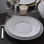 Porcelain tableware ECUME. Subtle effects within the material, masterful glazing work, the hollow engraving of ECUME makes for a contemporary and poetic collection that produces a highly elegant and modern table setting.