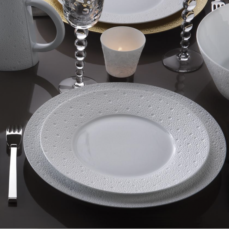 Porcelain tableware ECUME. Subtle effects within the material, masterful glazing work, the hollow engraving of ECUME makes for a contemporary and poetic collection that produces a highly elegant and modern table setting.